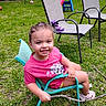 backyard, chair, child, fun, girl, grass, happy, nature, outdoor, person, pink_shirt, play, plush, sandals, slide, smiling, stick, summer, toy, unicorn