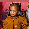 Mylah joined the competition — help win amazing prizes! toddler, child, smiling, braids, beads, jacket, brown_jacket, purse, sparkly, gift_box, indoor, portrait, cute, fashion, accessory, happy, person, young_child, ornate_chair, festive