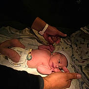 Luis Daniel Pulido joined the competition — help win amazing prizes! newborn, baby, infant, hospital, blanket, diaper, hat, striped_hat, lying_down, sleeping, awake, face, hand, adult, parent, portrait, indoors, medical, hospital_bedding, family