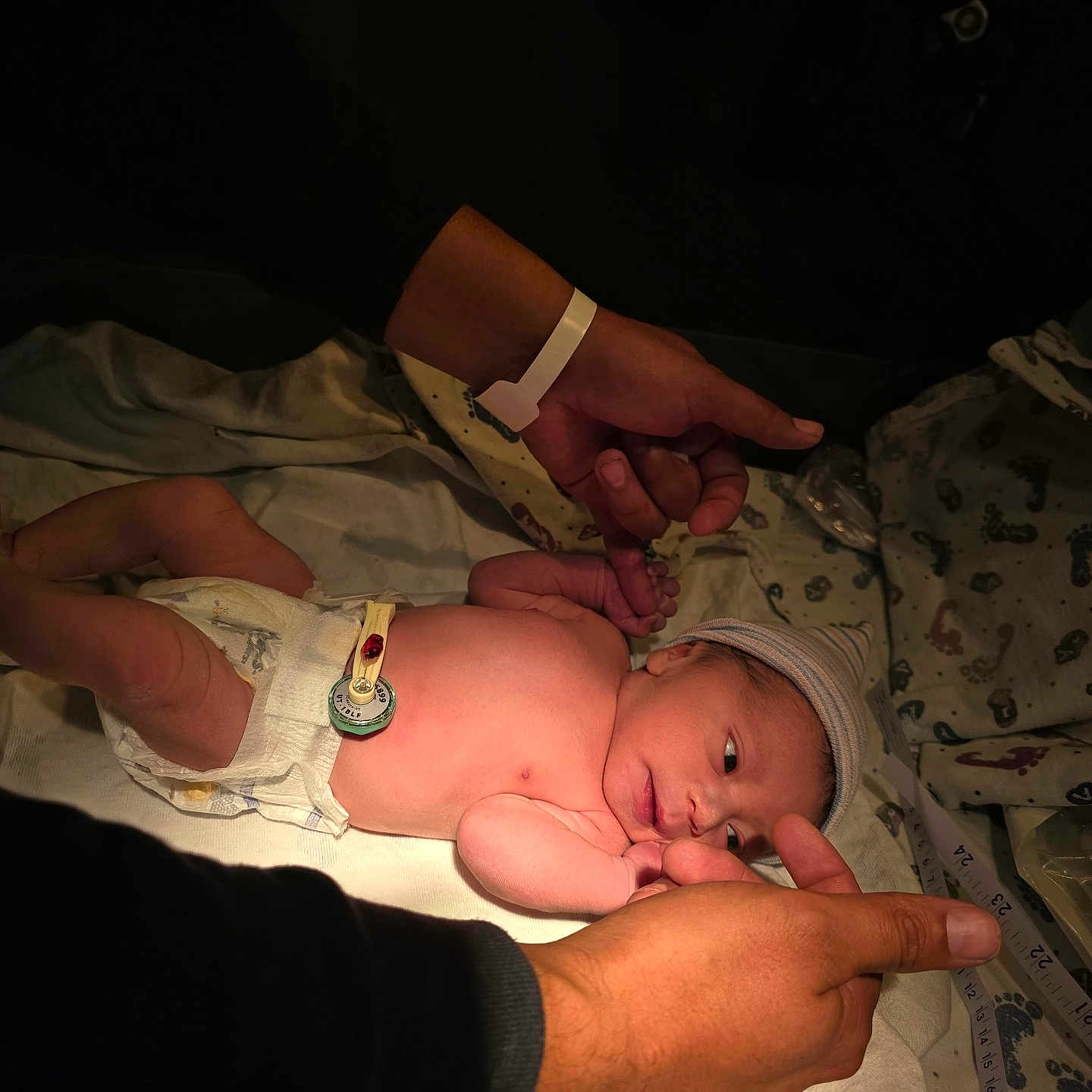 Luis Daniel Pulido joined the competition — help win amazing prizes! newborn, baby, infant, hospital, blanket, diaper, hat, striped_hat, lying_down, sleeping, awake, face, hand, adult, parent, portrait, indoors, medical, hospital_bedding, family