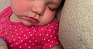 Drew is registered to the contest to win money with this photo: toddler, child, sleeping, pink_shirt, hearts_pattern, plush_toy, cushion, rosy_cheeks, peaceful, closeup, face, eyelashes, indoor, resting, cozy, soft_texture, cute, portrait, young_child, nap_time