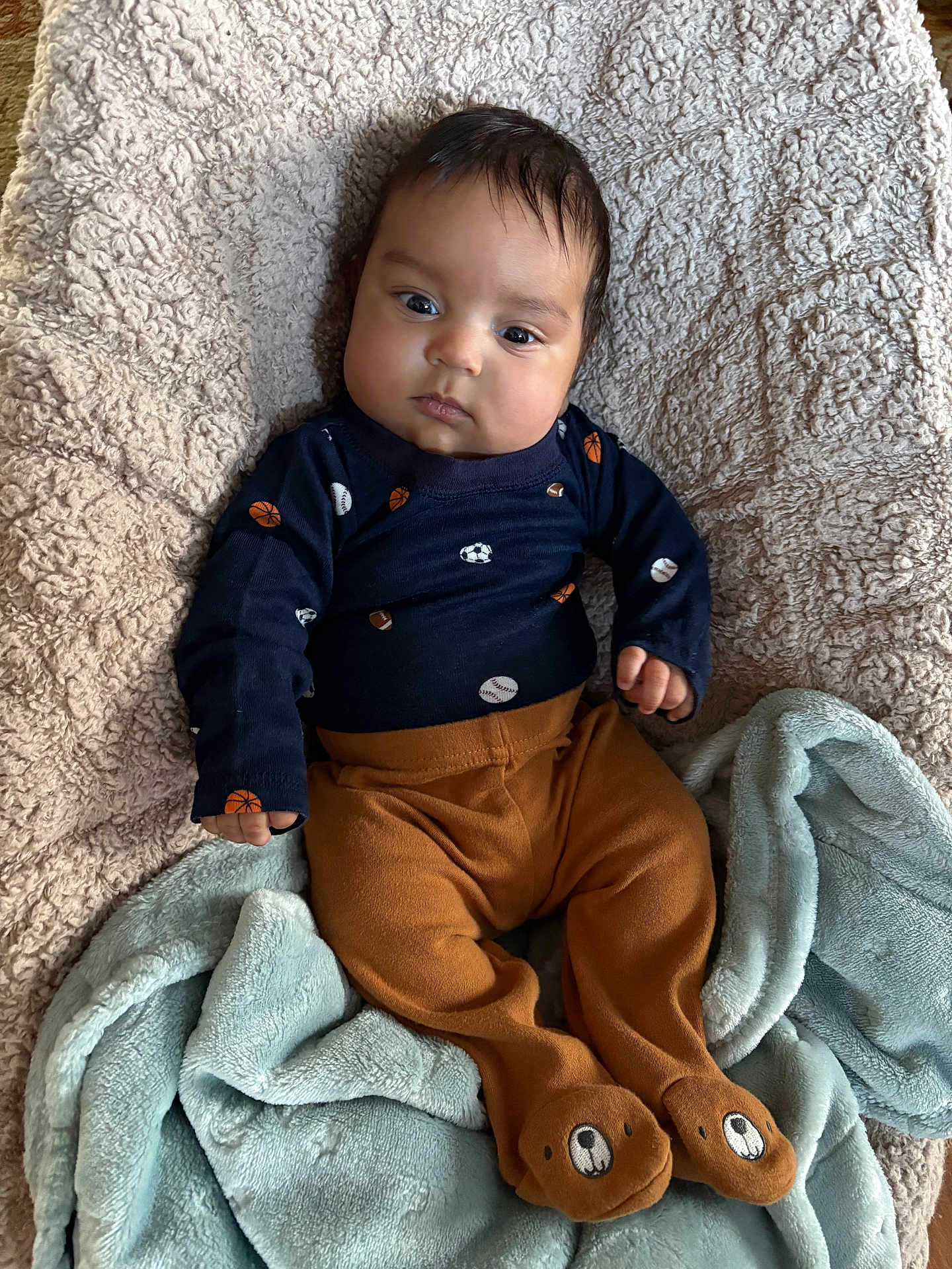 Atreus joined the competition — help win amazing prizes! baby, infant, blanket, blue_blanket, brown_pants, bear_feet, navy_blue_top, sports_pattern, face, eyes, hands, soft_texture, lying_down, indoors, cute, child, portrait, clothing, warm, resting