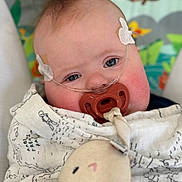 Truman joined the competition — help win amazing prizes! baby, infant, pacifier, blanket, nasal_cannula, face, blue_eyes, plush_toy, bunny, cute, medical, child, indoors, soft_toy, wrapped, closeup, head, expression, comfort, young_child