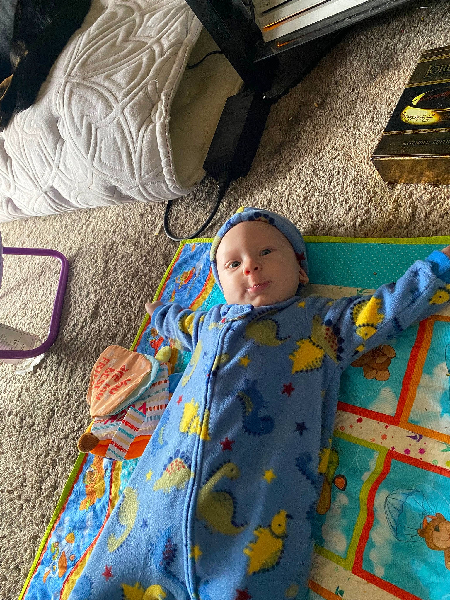 Richard is registered to the contest to win money with this photo: baby, baby_products, baby_toddler_clothing, baby_toys, child, comfort, flooring, fun, headwear, leisure, linens, pattern, people, person, play, room, sitting, textile, toddler, vacation