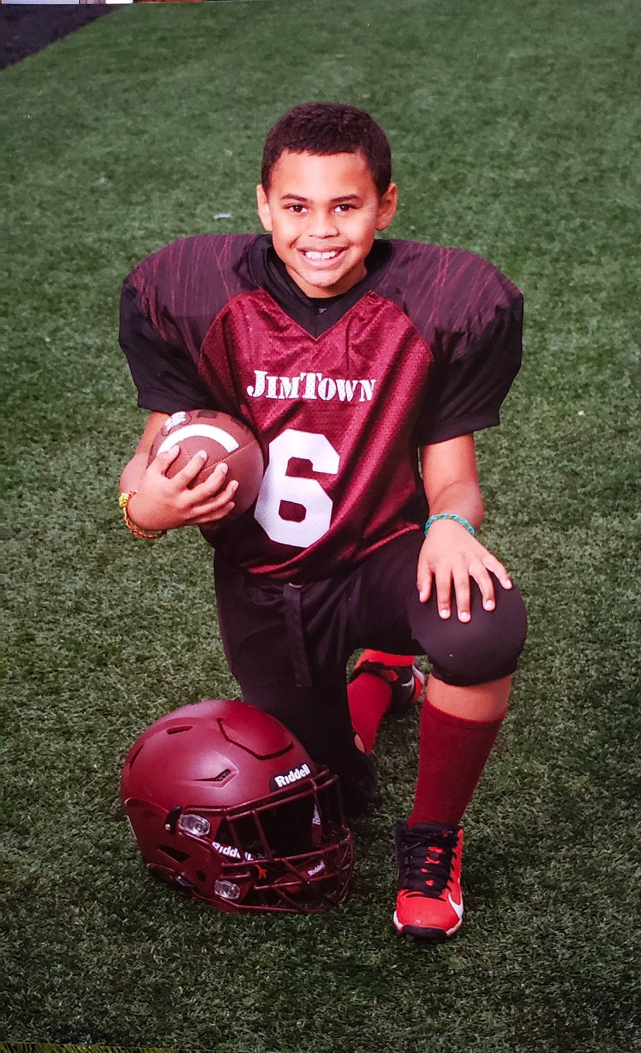 Noah is registered to the contest to win money with this photo: ball, ball_game, carmine, football, football_equipment, football_player, jersey, joy, knee, mammal, person, personal_protective_equipment, player, playing_sports, shoe, soccer_ball, sports, sports_equipment, sports_gear, sports_uniform