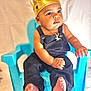 baby, child, crown, blue_chair, overalls, jewelry, golden_crown, portrait, cute, sitting, person, indoor, infant, baby_clothes, bracelet, necklace, expression, skin, foot, hand