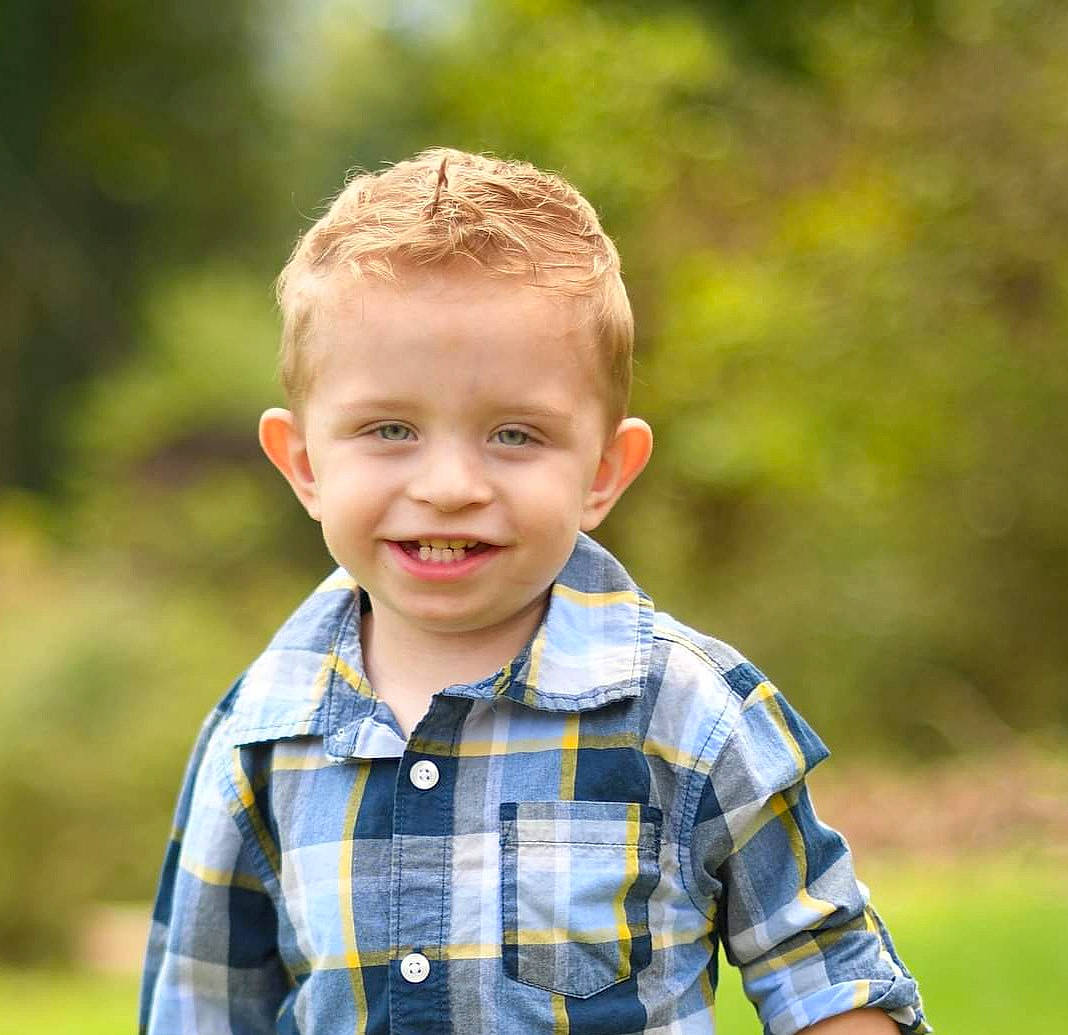 Josiah is registered to the contest to win money with this photo: child, chin, electric_blue, eye, flash_photography, fun, grass, grassland, happy, head, joy, leisure, pattern, people_in_nature, person, plaid, sleeve, smile, summer, t_shirt