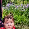 Lina joined the competition — help win amazing prizes! toddler, child, stroller, red_clothing, outdoor, grass, purple_flowers, mountain, sky, clouds, nature, greenery, portrait, cute, baby, summer, daylight, person, sitting, scenic