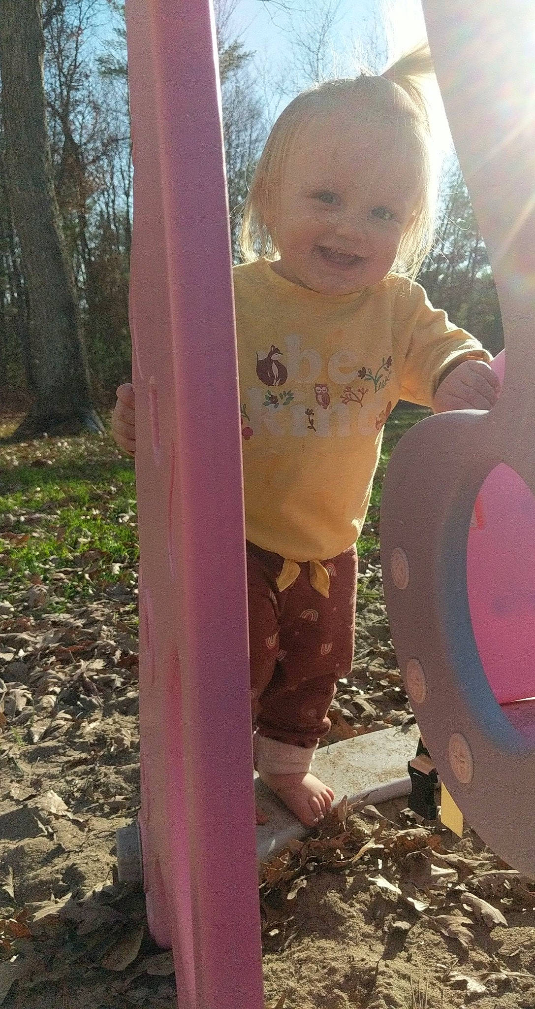 Maggie is registered to the contest to win money with this photo: baby, baby_toddler_clothing, child, fun, grass, hairstyle, happy, joy, leaf, leisure, outdoor_play_equipment, people_in_nature, person, pink, plant, play, recreation, smile, standing, tints_and_shades