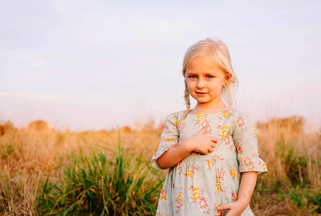Tegan joined the competition — help win amazing prizes! child, dress, grass, grass_family, grassland, happy, people, people_in_nature, person, photograph, photography, plant, portrait, portrait_photography, skin, sky, smile, summer, sunlight, toddler