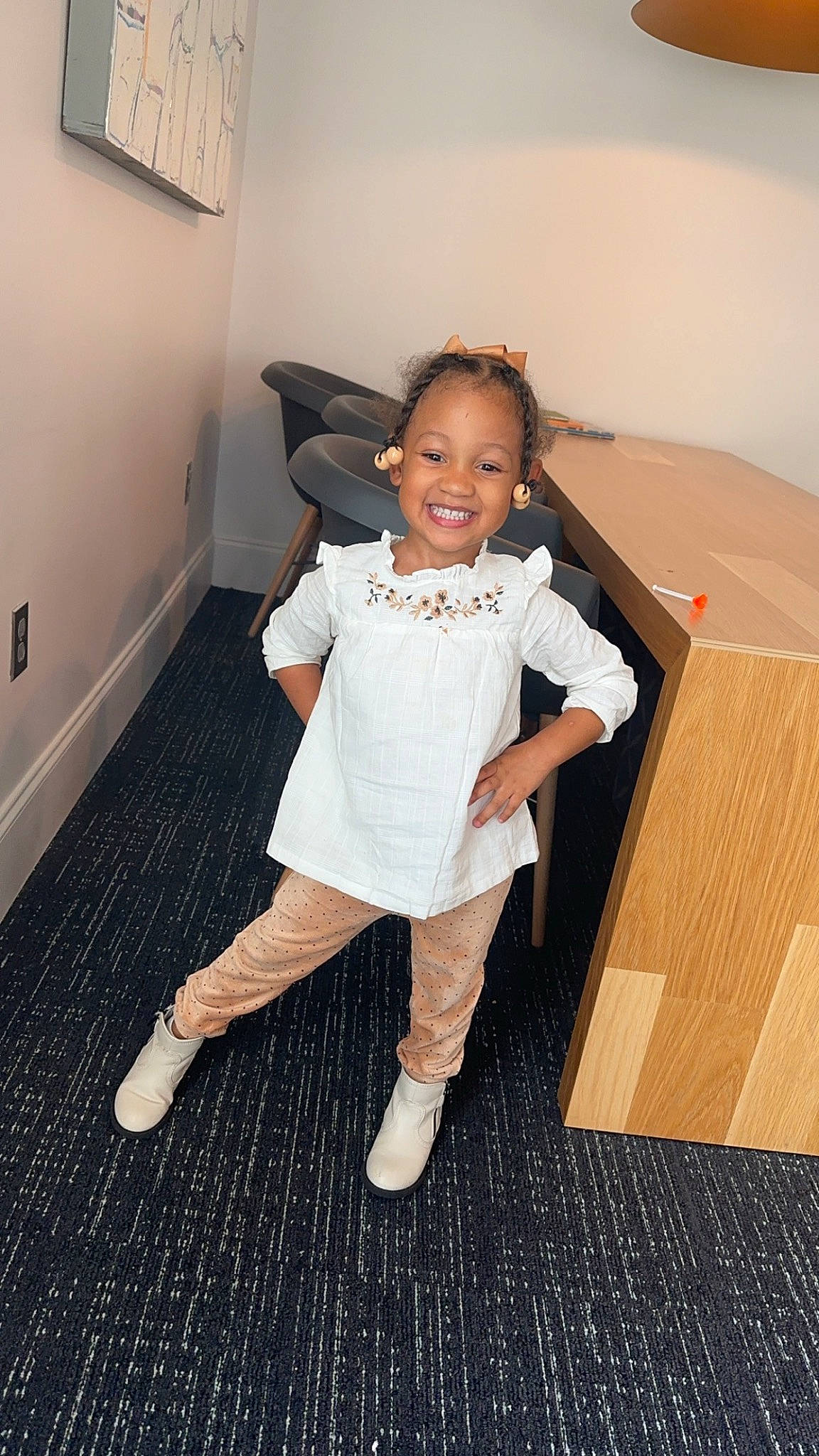 Haleigh is registered to the contest to win money with this photo: baby_toddler_clothing, child, floor, flooring, footwear, fun, gesture, happy, hardwood, human_leg, joy, knee, person, shoe, sleeve, smile, sneakers, sock, standing, thigh