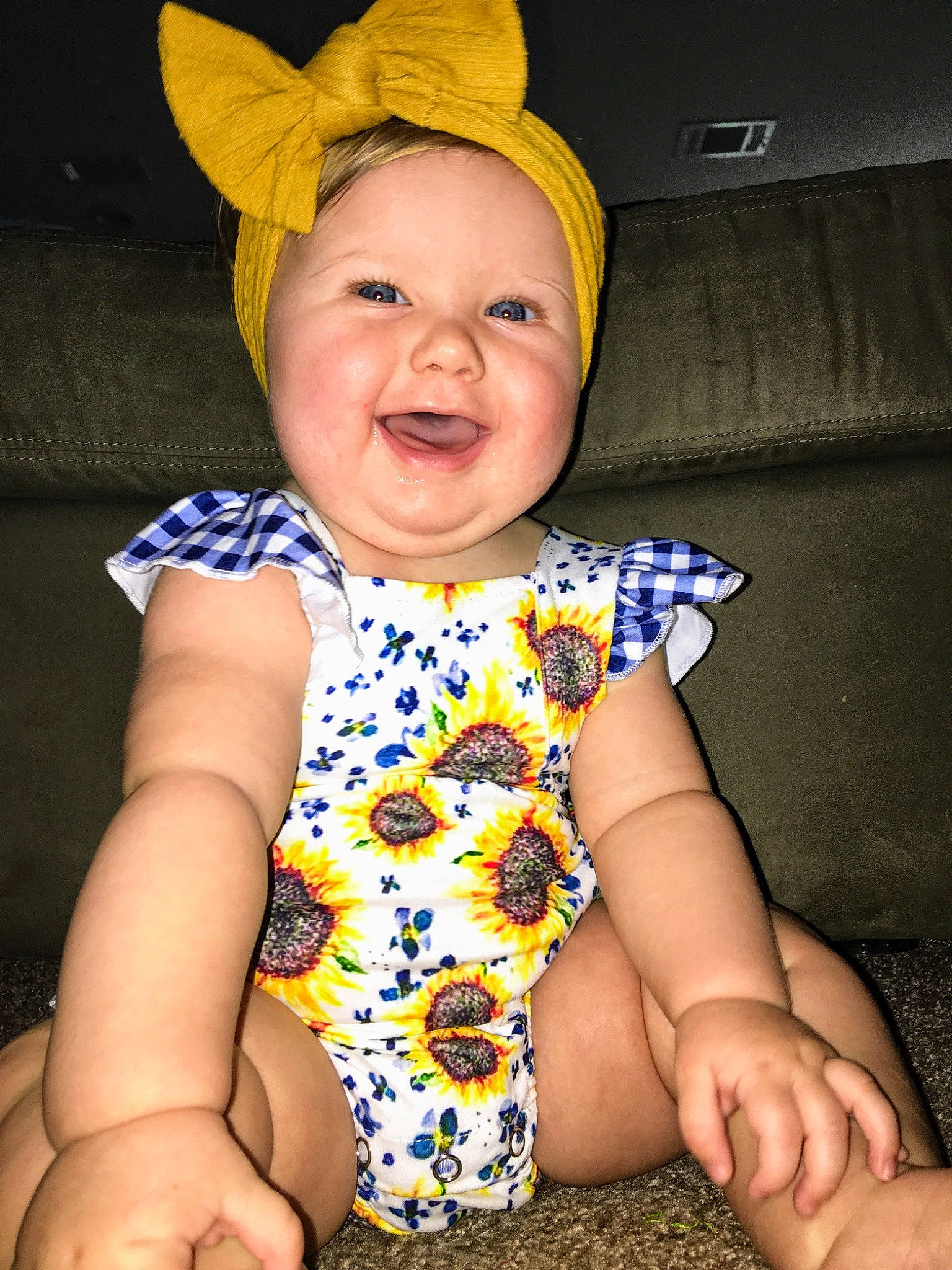 Caroline is registered to the contest to win money with this photo: baby, baby_laughing, baby_toddler_clothing, cap, child, costume_accessory, eye, face, happy, hat, head, headgear, headwear, person, skin, sleeve, smile, toddler, yellow