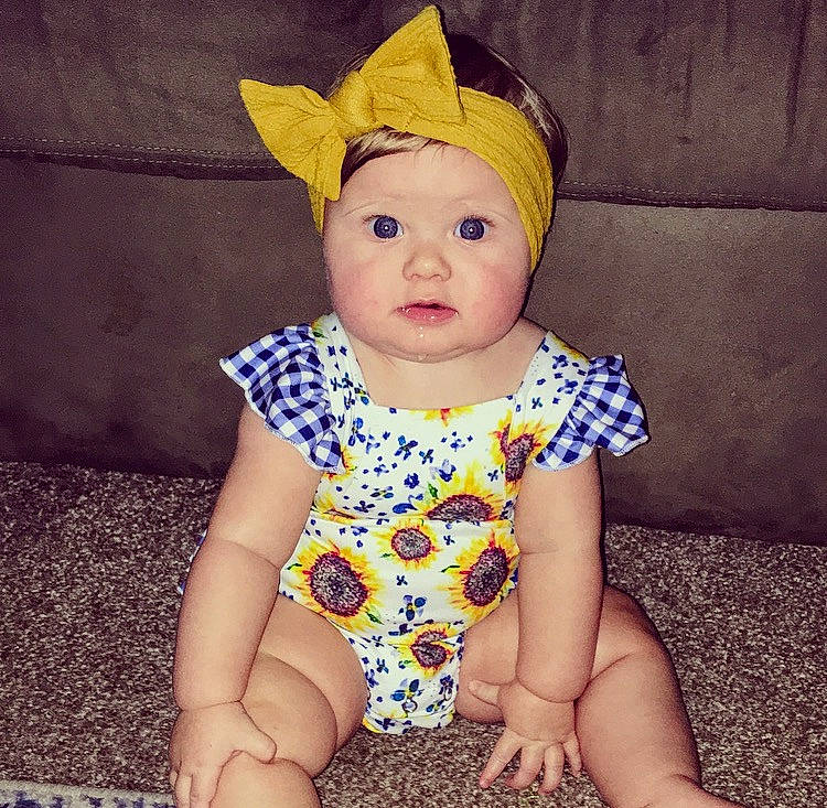 Caroline is registered to the contest to win money with this photo: baby, baby_toddler_clothing, child, cool, costume_accessory, design, ear, eye, face, fashion_accessory, head, headgear, headwear, organ, pattern, person, skin, sleeve, smile, toddler