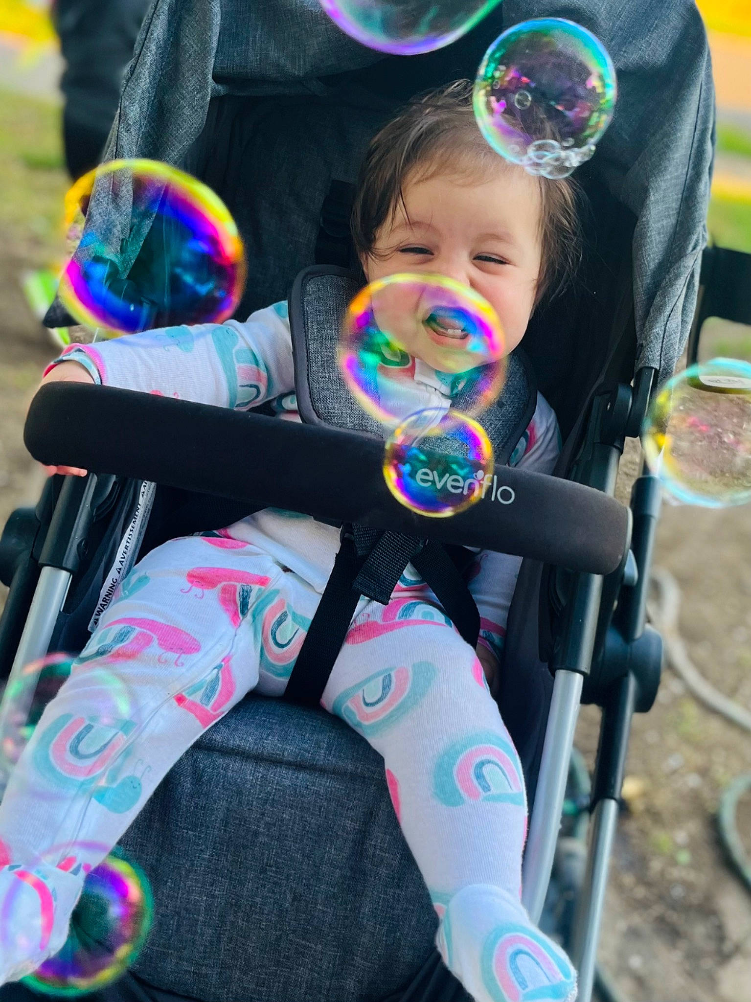 Teagan is registered to the contest to win money with this photo: baby, baby_carriage, baby_products, baby_toddler_clothing, child, event, face, fun, goggles, grass, happy, leisure, person, personal_protective_equipment, play, product, recreation, sitting, snapshot, sunglasses