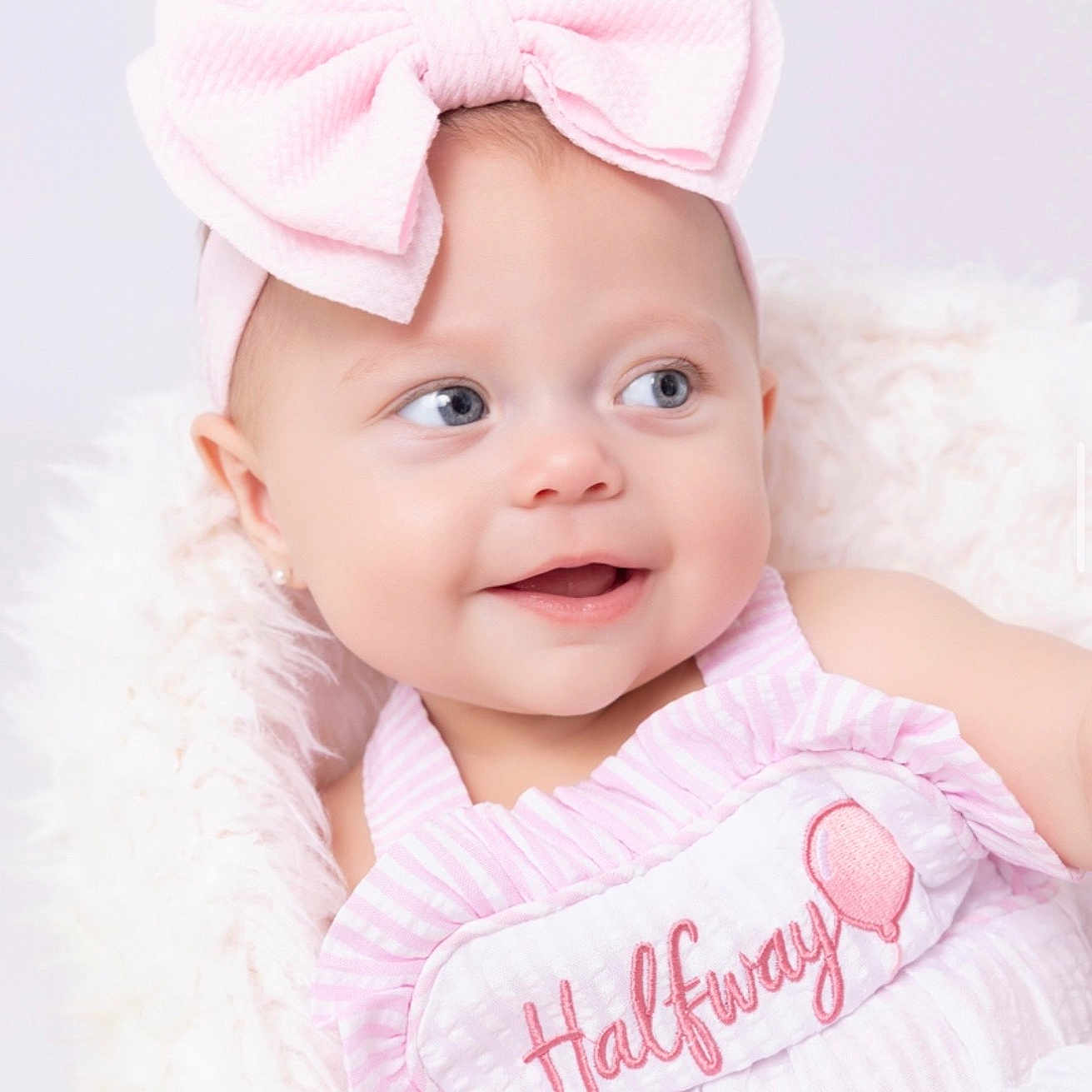 Taytum is registered to the contest to win money with this photo: baby, child, infant, pink_bow, blue_eyes, smile, cute, headband, clothing, blanket, soft_texture, portrait, happy, closeup, cute_baby, baby_girl, adorable, infant_clothing, baby_fashion, soft_lighting