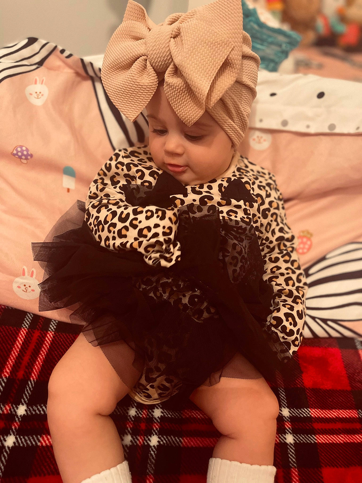 Melania is registered to the contest to win money with this photo: baby, child, design, event, fashion, fun, happy, headwear, human_body, human_leg, pattern, person, pink, plaid, sitting, sleeve, tartan, textile, thigh, toddler