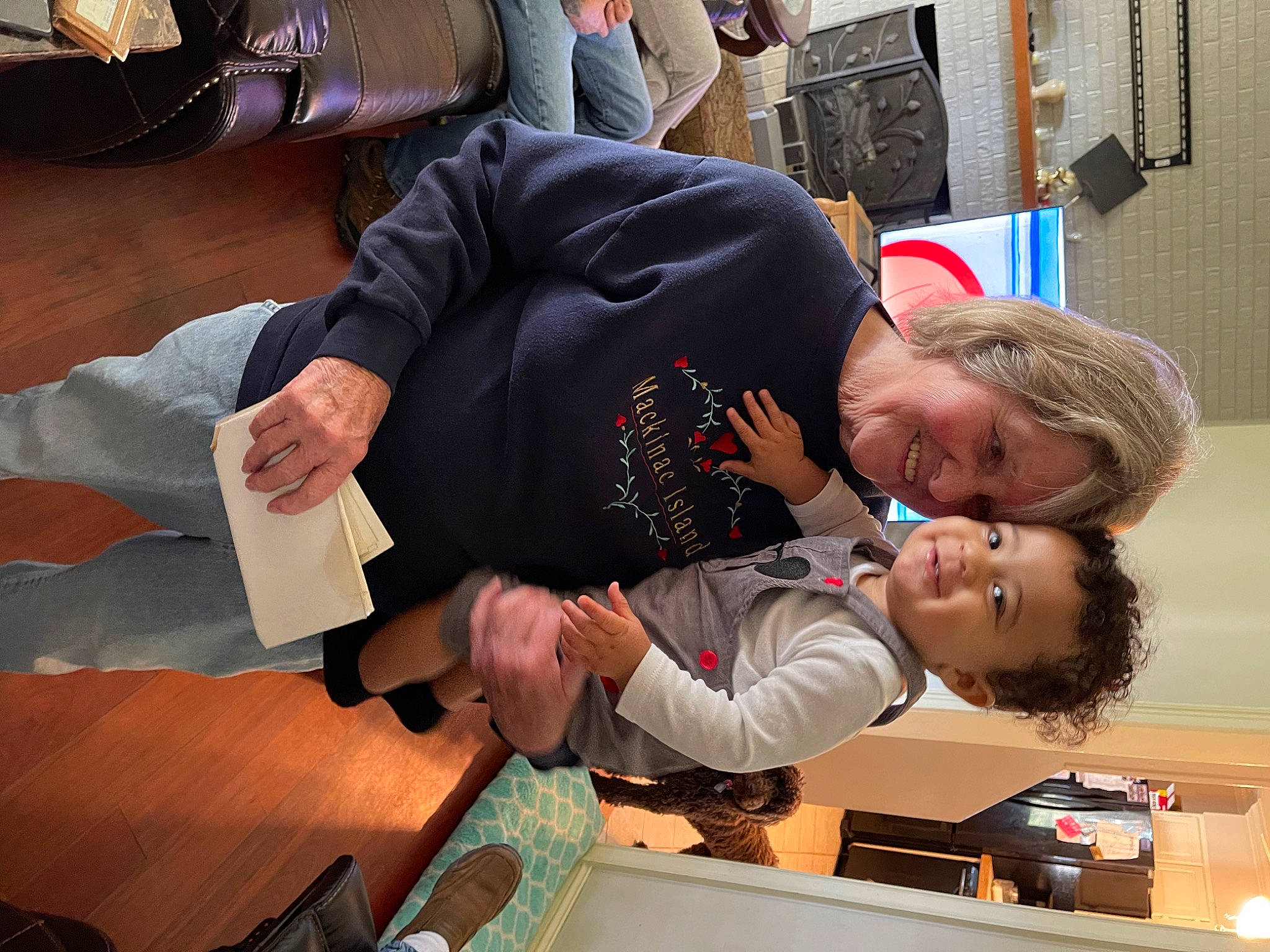 Landyn is registered to the contest to win money with this photo: child, comfort, event, fun, gesture, joy, person, room, sitting, suit, toddler, tree, wood