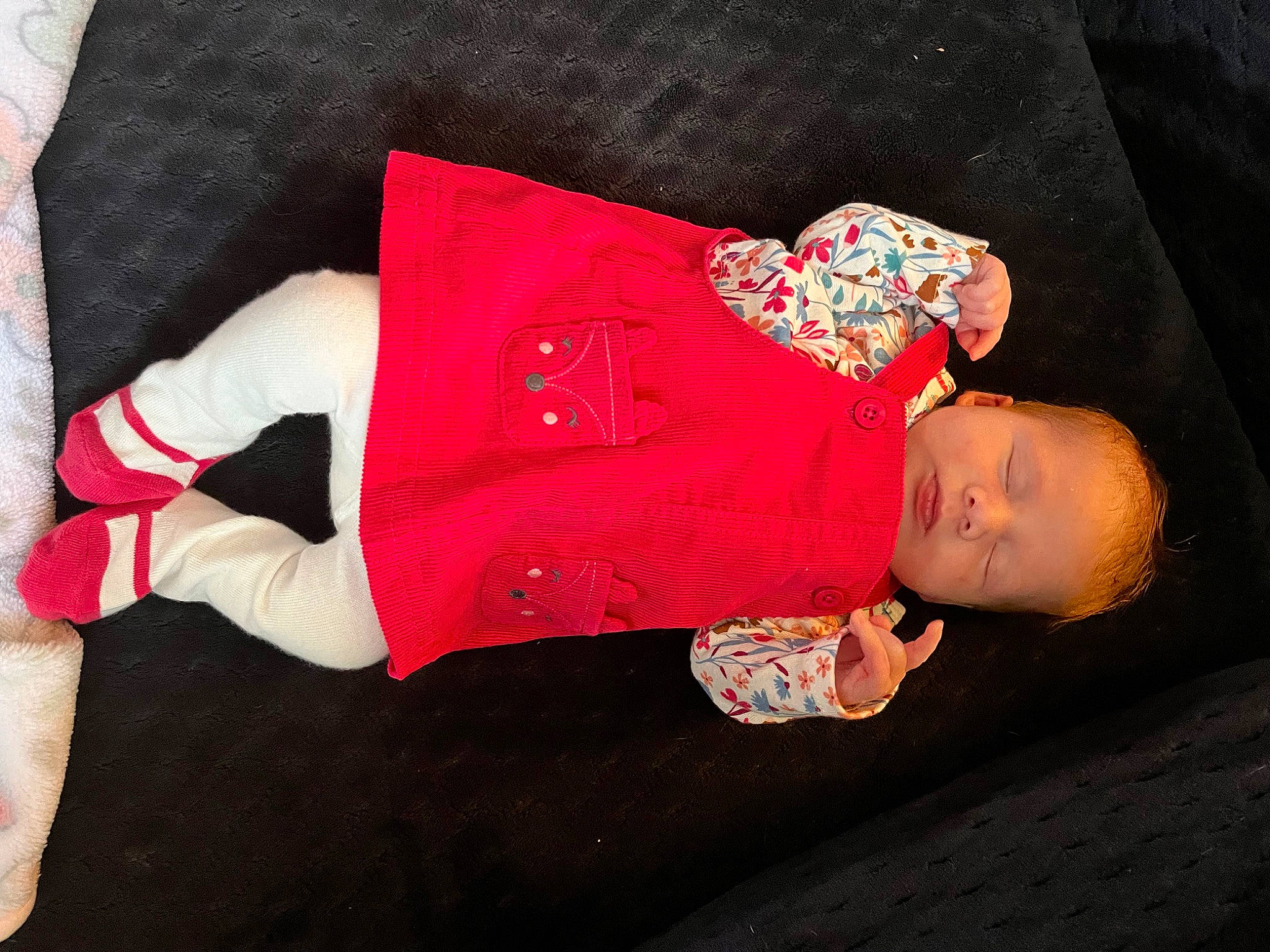 Kyla is registered to the contest to win money with this photo: baby, baby_products, baby_toddler_clothing, carmine, child, dress, embellishment, fashion_accessory, flooring, hand, headgear, human_body, magenta, pattern, person, sleeve, sock, textile, toddler, wood
