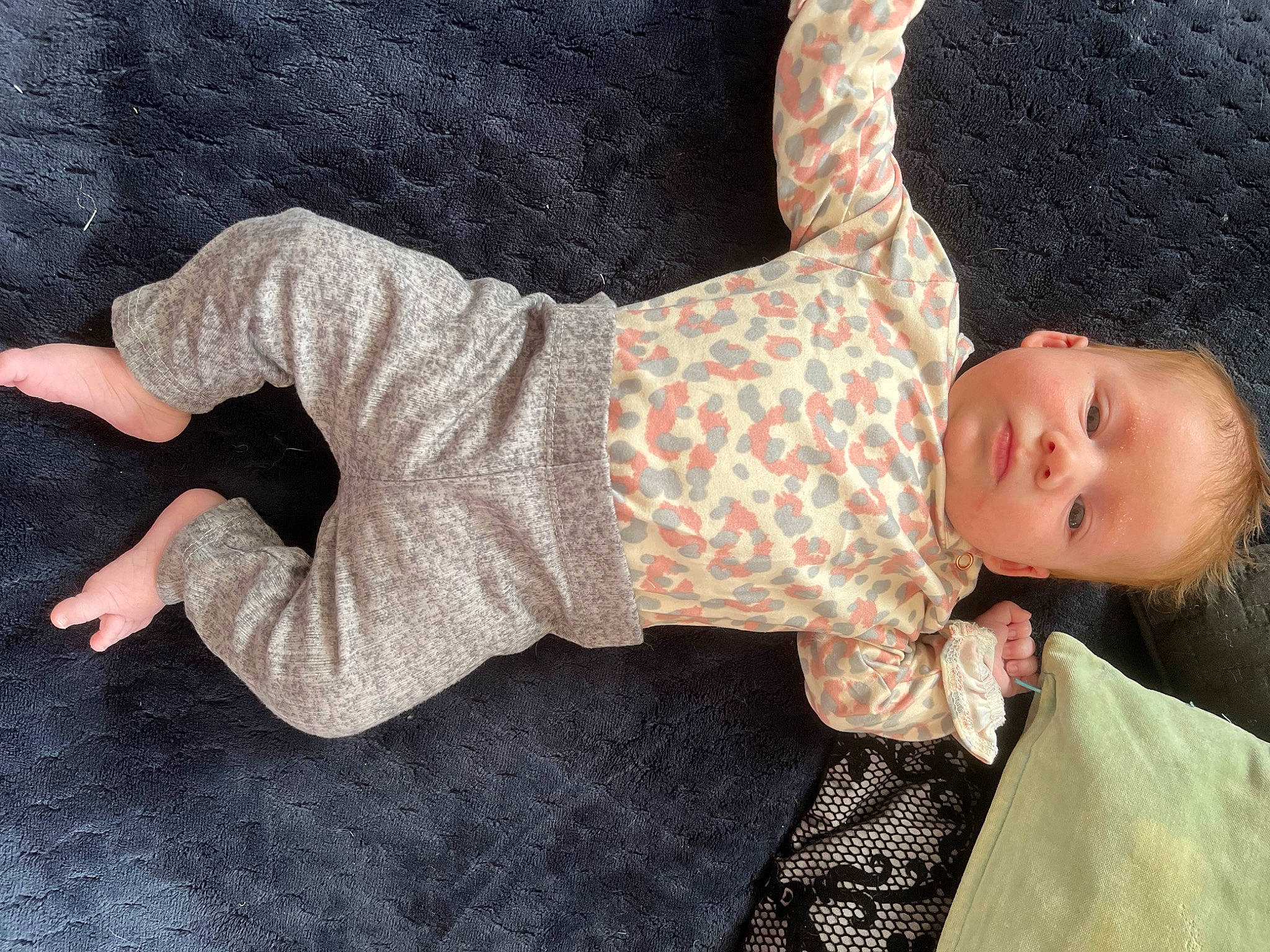 Kyla is registered to the contest to win money with this photo: baby, baby_products, baby_toddler_clothing, child, comfort, doll, flooring, foot, human_body, human_leg, linens, nightwear, pattern, person, sitting, sleeve, sock, toddler, toy, wood