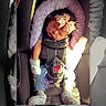 baby, infant, child, sleeping, car_seat, seatbelt, bow, headband, socks, pacifier, vehicle, travel, sunlight, portrait, close_up, color_photo, black_and_white, cozy, safe, seated