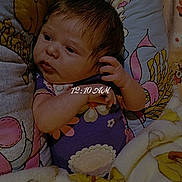 Izabelle is registered to the contest to win money with this photo: baby, bed, bedding, blanket, cartoon, child, colorful, ear, eyes, face, floral, hair, hand, indoors, infant, lying_down, newborn, portrait, sleepy, timestamp