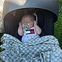 baby, infant, car_seat, pacifier, blanket, sleeping, outdoor, grass, shade, clothing, newborn, child, resting, cute, peaceful, relaxing, portrait, head, small_hands, toddler