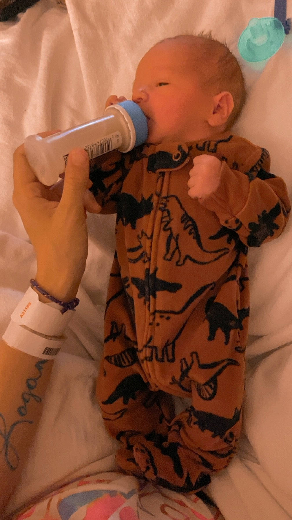 Jakx Andrew is registered to the contest to win money with this photo: baby, baby_toddler_clothing, camouflage, drinkware, face, finger, gesture, hairstyle, head, joint, military_camouflage, mouth, nail, neck, person, skin, sleeve, thigh, thumb, toddler