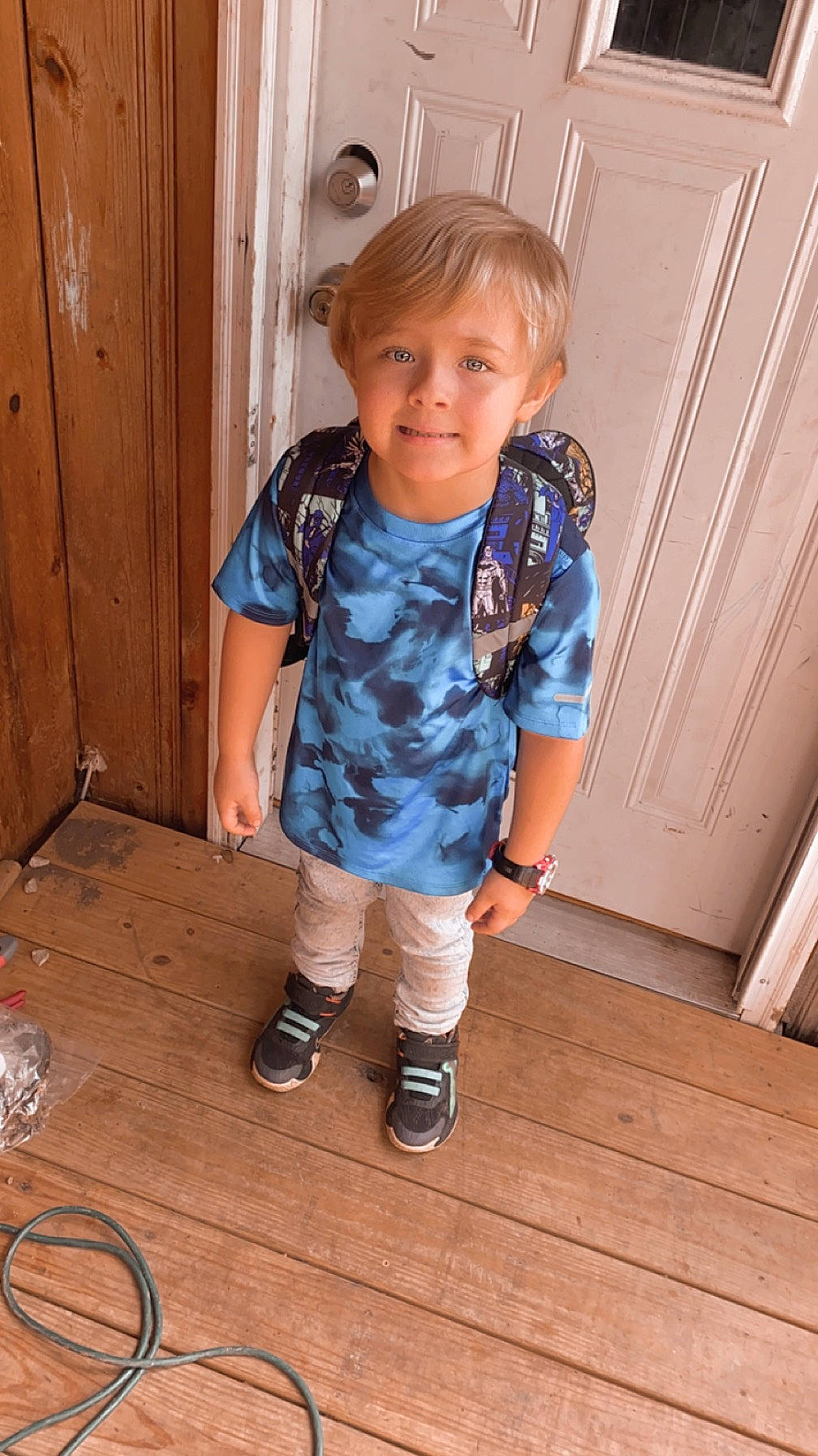 Logan joined the competition — help win amazing prizes! baby_toddler_clothing, child, door, electric_blue, floor, flooring, footwear, hardwood, human_leg, joy, knee, pattern, person, shoe, sleeve, standing, t_shirt, toddler, varnish, wood
