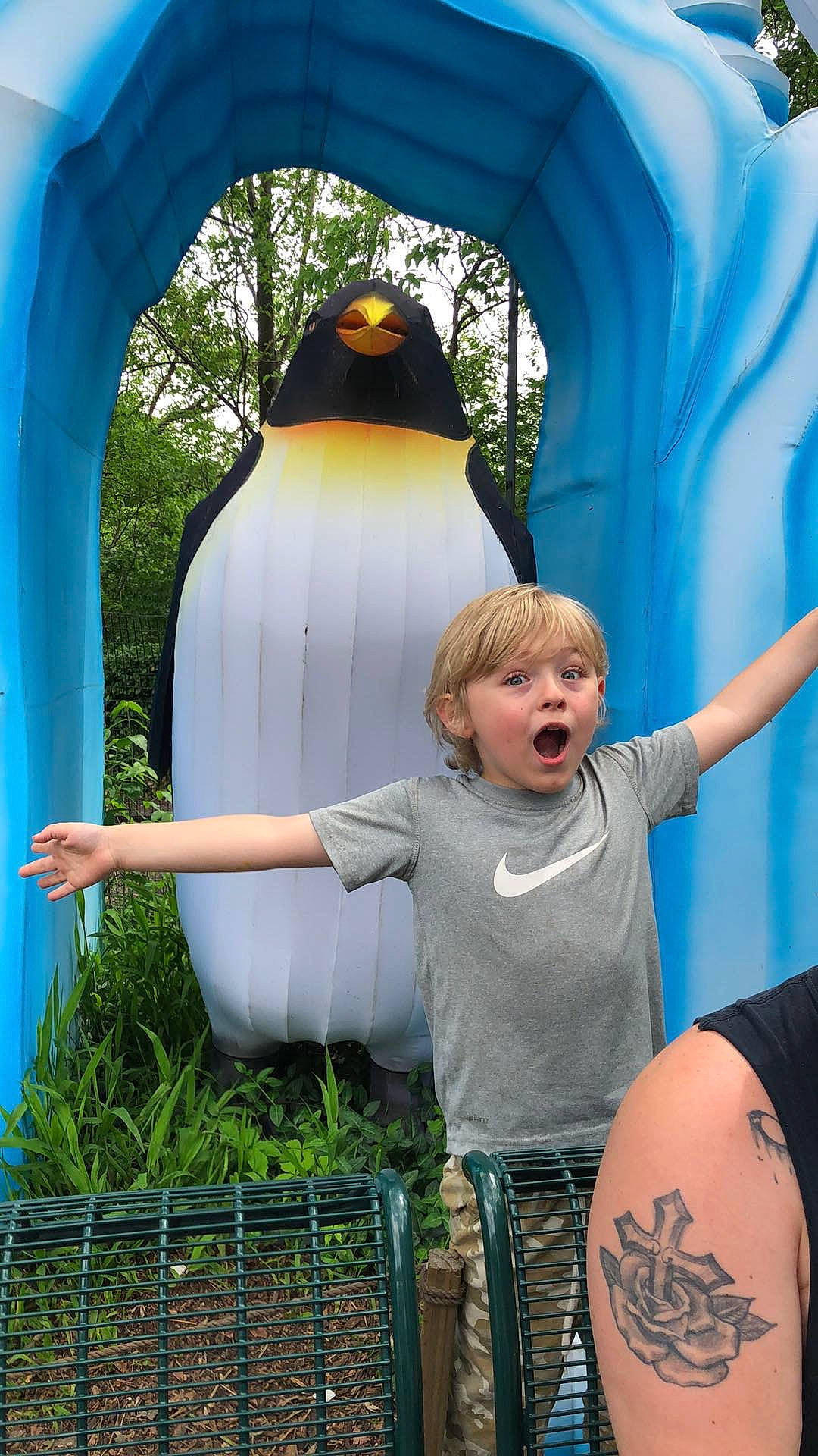 Logan joined the competition — help win amazing prizes! beauty, blue, child, electric_blue, facial_expression, flightless_bird, fun, grass, happy, leisure, outdoor_play_equipment, penguin, people_in_nature, person, photograph, recreation, sitting, surprise, t_shirt, toddler