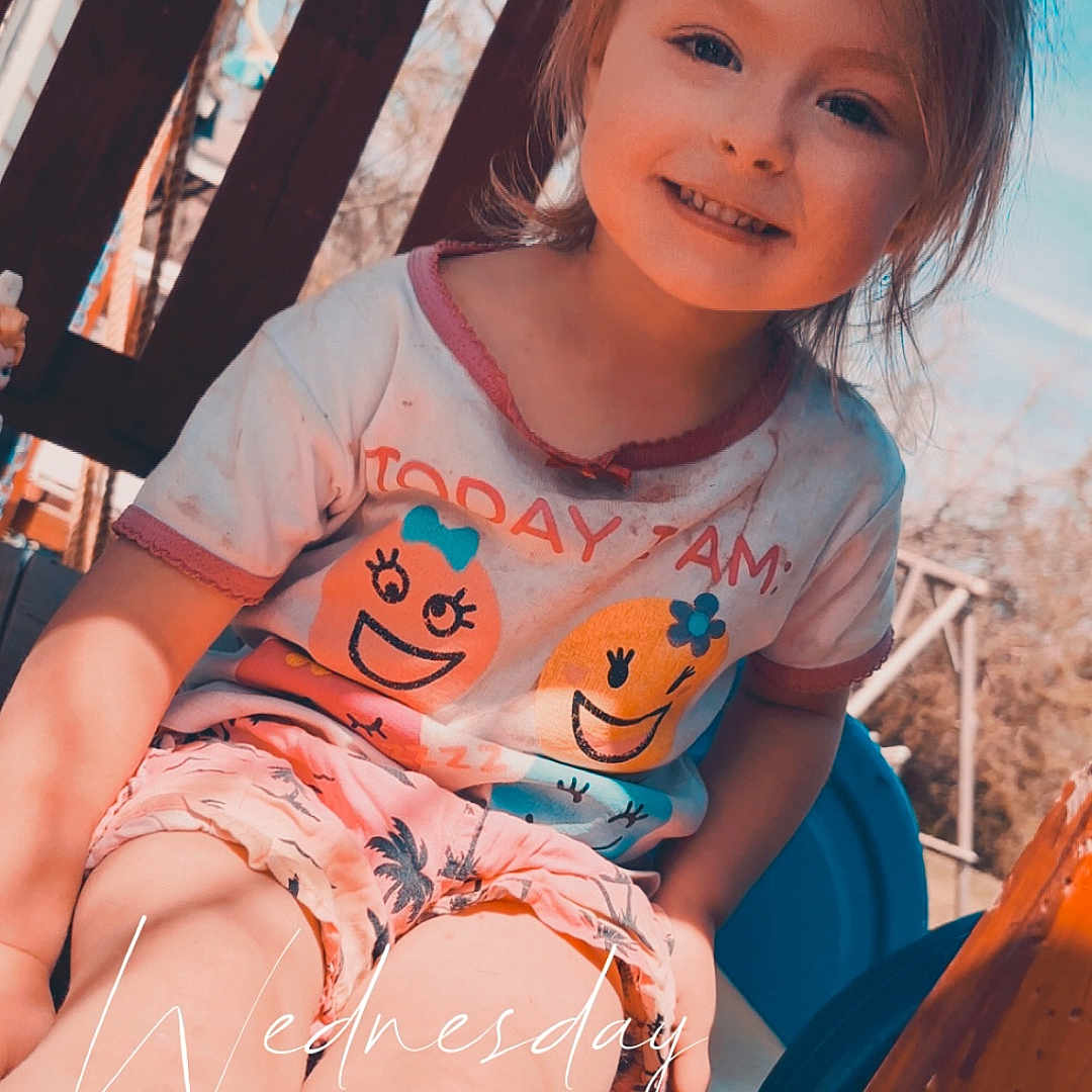 Harper Rose is registered to the contest to win money with this photo: bodypart, child, clothing, face, female, finger, girl, hand, happy, head, outdoorplayarea, outdoors, person, photography, playarea, portrait, shorts, sitting, smile, t_shirt