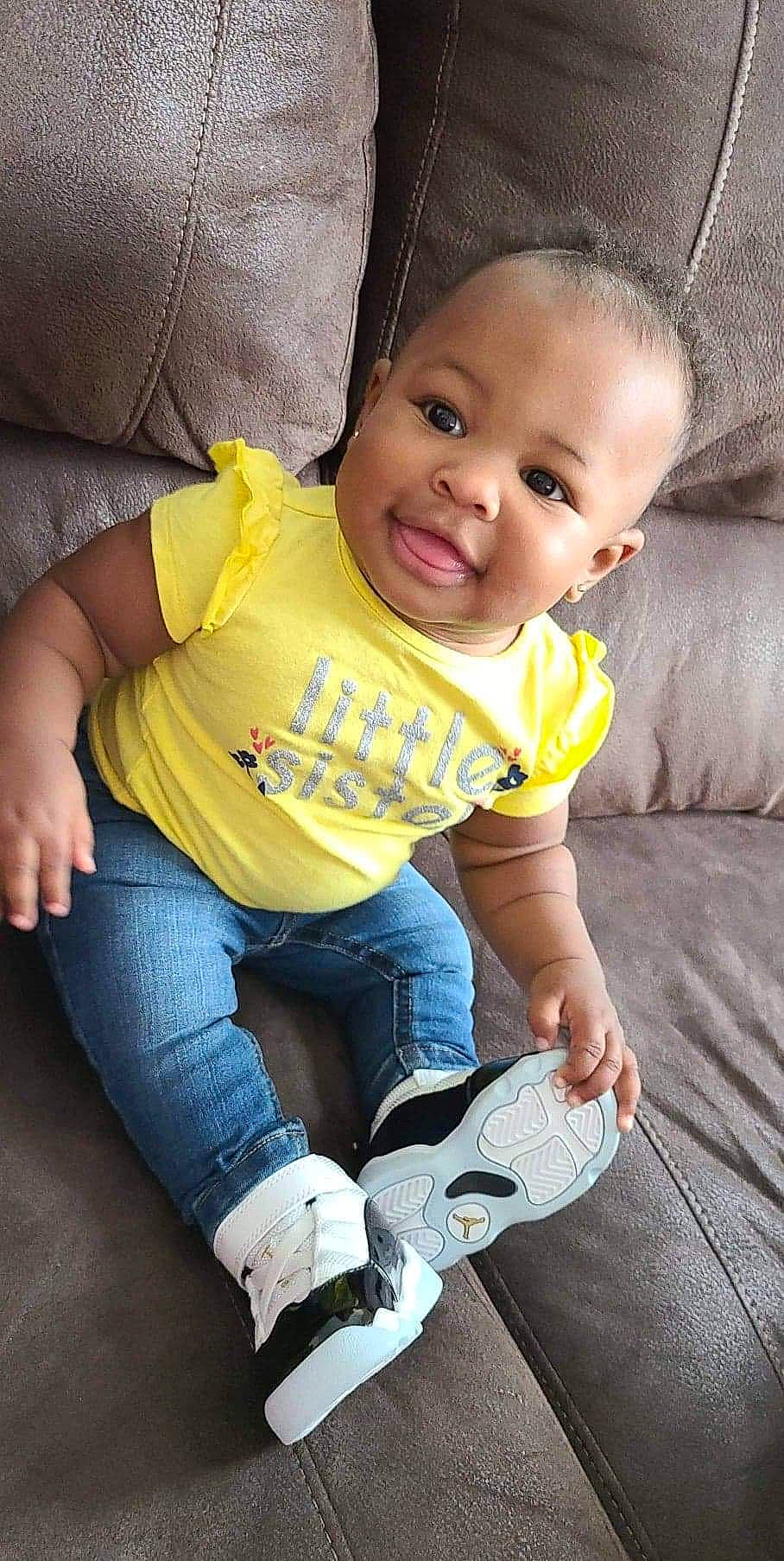 Semariah joined the competition — help win amazing prizes! baby_toddler_clothing, cheek, child, comfort, couch, denim, eye, foot, hand, human, jeans, joy, knee, lap, living_room, mammal, mouth, person, skin, sock