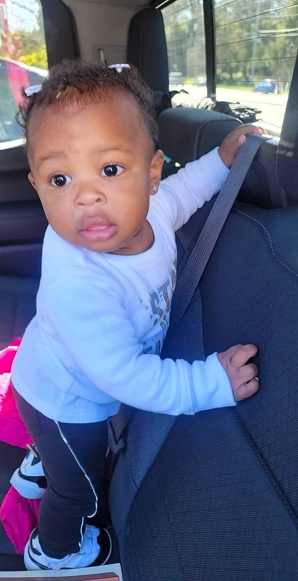 Semariah is registered to the contest to win money with this photo: active_pants, active_tank, armrest, baby, baby_toddler_clothing, car_seat, car_seat_cover, child, comfort, eye, eyelash, head_restraint, lap, leggings, person, pink, sweatpant, thumb, toddler, vehicle_door