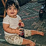 baby, child, indoor, sitting, carpet, bottle, drink, dr_pepper, clothing, patterned_pants, barefoot, wet_hair, blue_eyes, tongue_out, cute, floor, furniture, slippers, toy_vehicle, happy