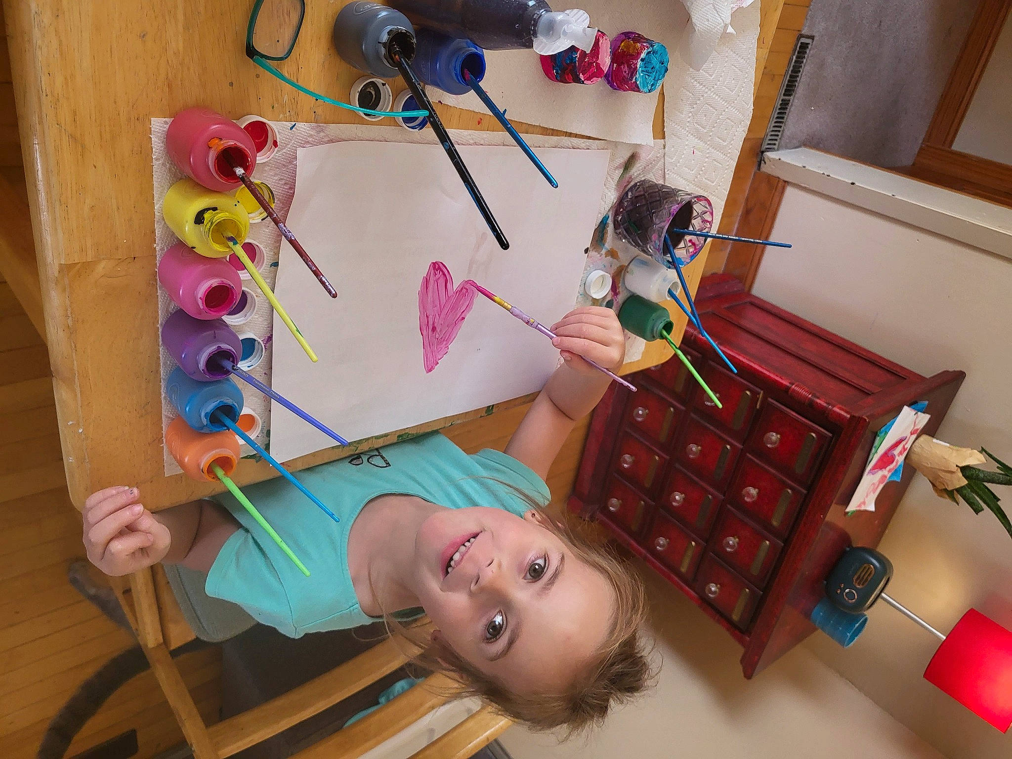 Lyla is registered to the contest to win money with this photo: art, chair, child, child_art, flooring, fun, house, illustration, joy, leisure, office_supplies, paint, pattern, person, play, room, sandal, stationery, toddler, visual_arts