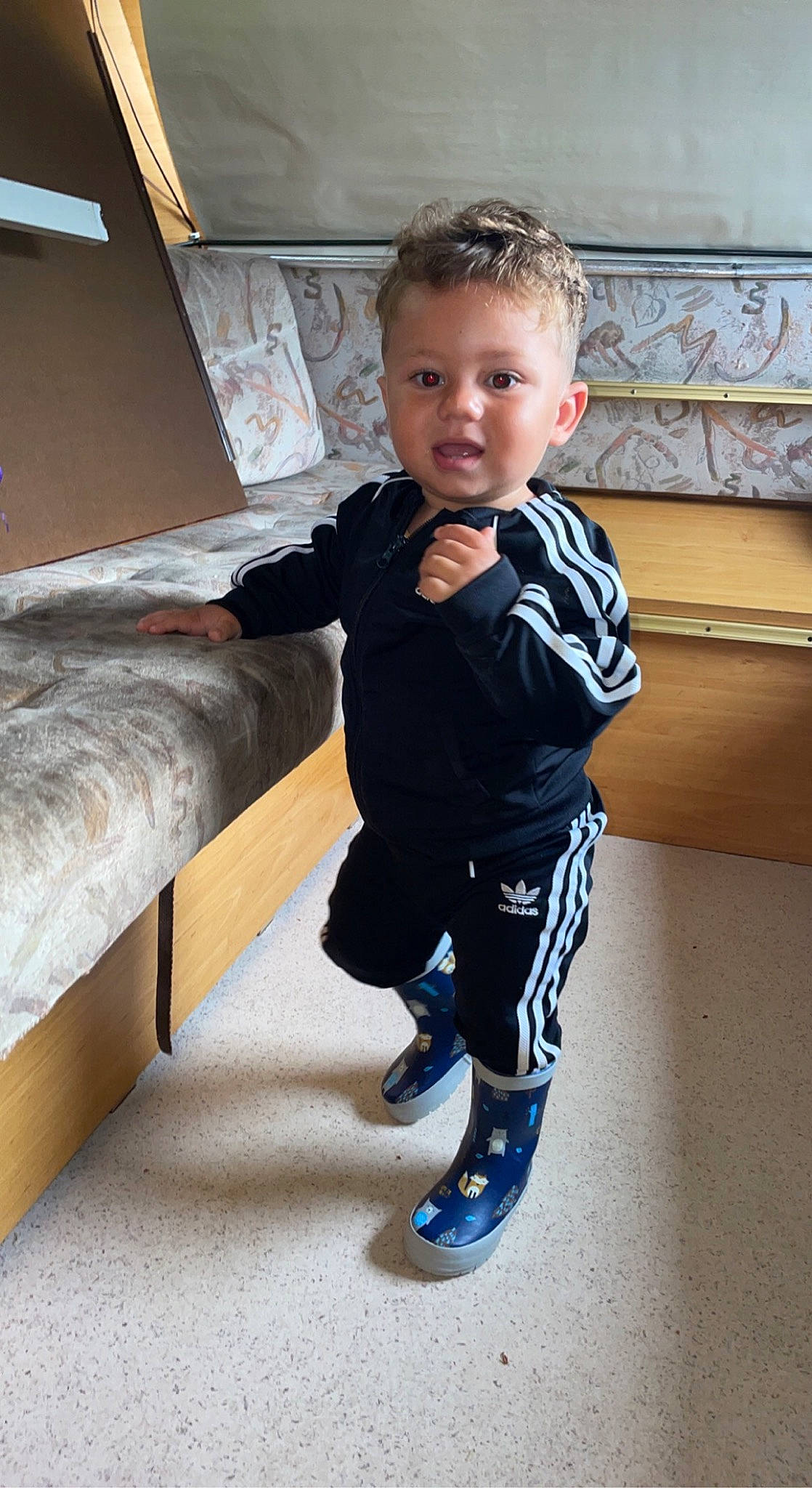 Isaac participe au concours pour gagner de l'argent avec cette photo : baby_toddler_clothing, comfort, couch, electric_blue, fashion_design, flooring, formal_wear, fun, hardwood, knee, person, pillow, sitting, sleeve, sock, sofa_bed, studio_couch, suit, toddler, vertebrate