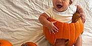 Oshea is registered to the contest to win money with this photo: baby, pumpkin, halloween, hat, white_background, smiling, infant, holiday, orange, white_pumpkin, plaque, celebration, child, cute, festive, sitting, face, hands, feet, costume