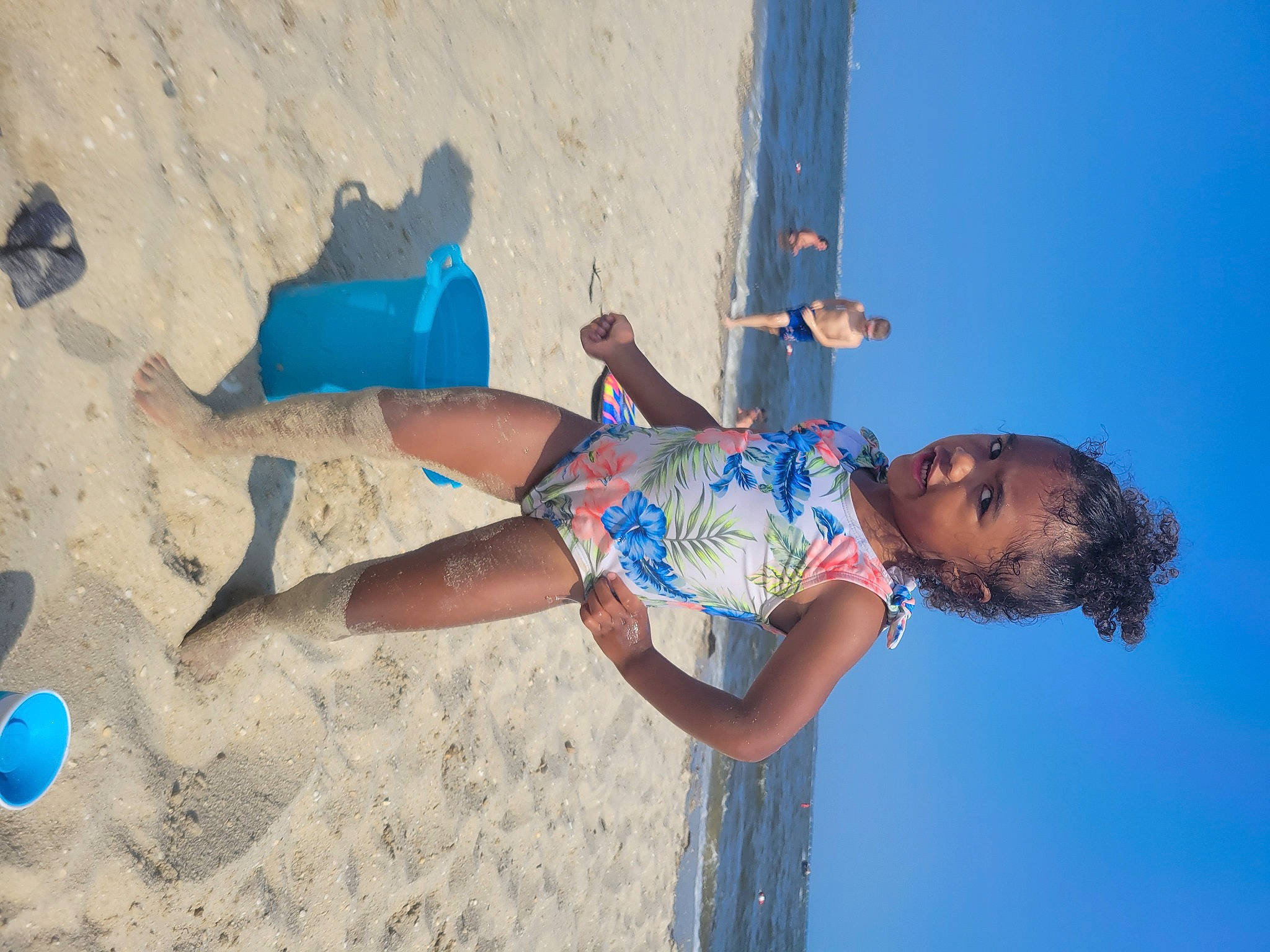 Willow is registered to the contest to win money with this photo: arm, azure, barefoot, beach, blue, calf, elbow, electric_blue, foot, fun, happy, human_body, human_leg, leg, leisure, person, recreation, sand, thigh, toddler