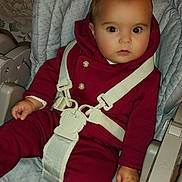 Liam participe au concours pour gagner de l'argent avec cette photo : baby, child, high_chair, straps, maroon_clothing, socks, indoor, portrait, face, expression, seated, furniture, cushion, wallpaper, curious, young_child, infant, safety_harness, footwear, home