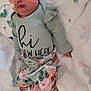 baby, newborn, sleeping, hat, floral_clothing, blanket, medical_tube, hospital, cute, soft, infant, child, person, lying_down, pink_socks, patterned_blanket, face, peaceful, indoors, resting