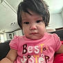 casual, child, closeup, clothing, couch, cute, expression, face, girl, hair, home, indoor, living_room, person, pink_shirt, portrait, sitting, text_on_clothing, toddler, young_child