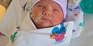 Madeline joined the competition — help win amazing prizes! newborn, baby, hospital, blanket, duck_pattern, hat, feeding_tube, crib, sleeping, infant, swaddled, medical, pediatric, cute, soft_lighting, patient, healthcare, bed, resting, child