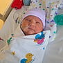 newborn, baby, hospital, blanket, duck_pattern, hat, feeding_tube, crib, sleeping, infant, swaddled, medical, pediatric, cute, soft_lighting, patient, healthcare, bed, resting, child