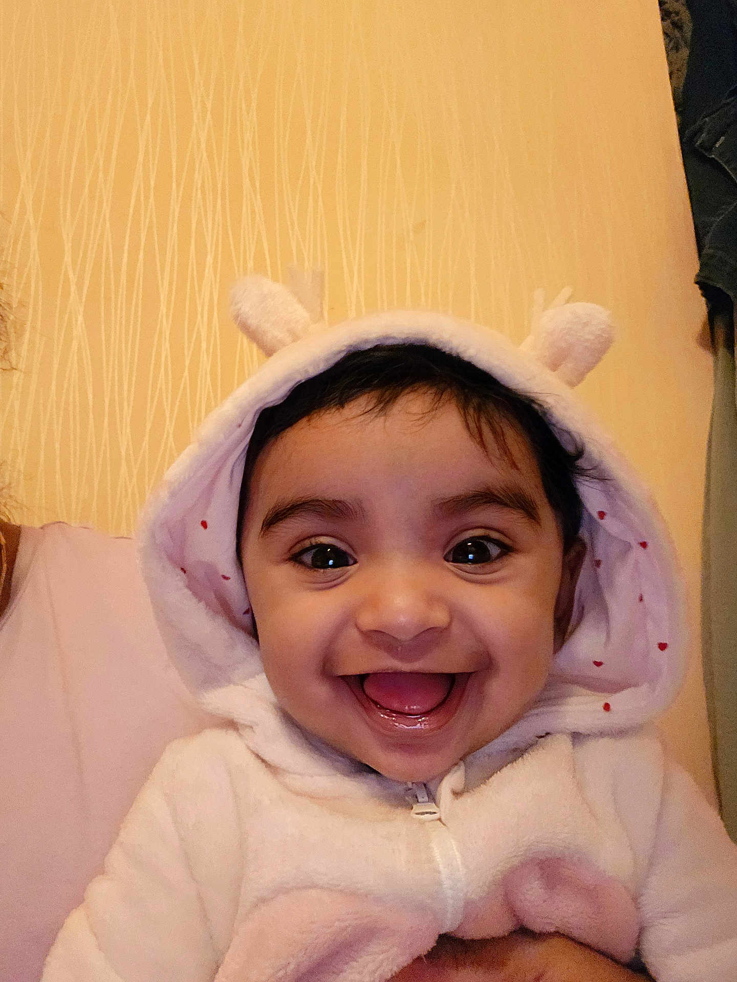 Emiliya is registered to the contest to win money with this photo: baby, child, hoodie, smile, happy, cute, ears, face, portrait, indoor, person, young_child, warm_lighting, closeup, infant, apparel, human, joyful, expression, soft_texture