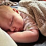 baby, sleeping, blanket, pillow, infant, cute, peaceful, resting, soft, cozy, child, face, skin, arm, closeup, indoors, comfort, relaxation, nap, serene