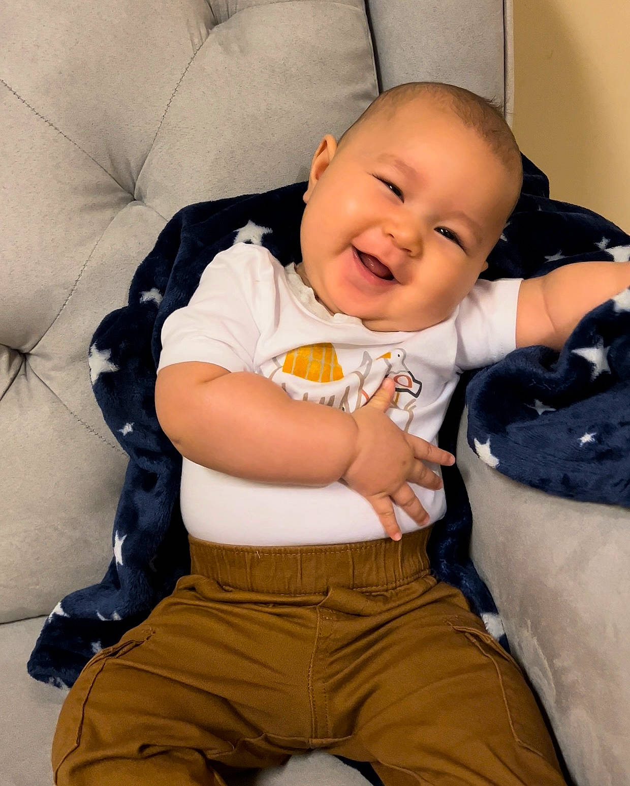 Lemuel is registered to the contest to win money with this photo: baby, baby_toddler_clothing, cheek, child, comfort, eye, finger, fun, happy, head, joy, linens, person, sitting, skin, sleeve, smile, t_shirt, thigh, thumb