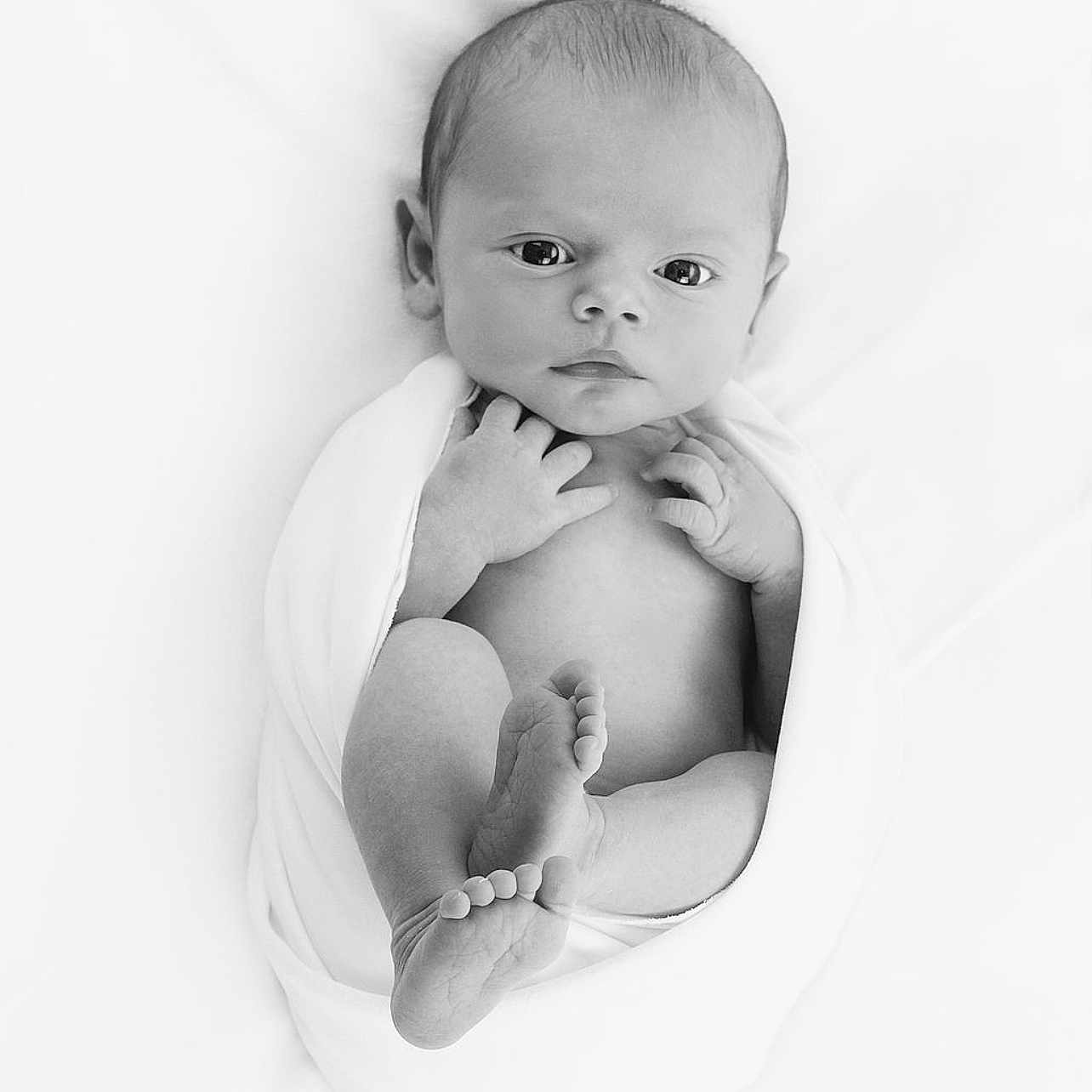 Marley is registered to the contest to win money with this photo: baby, black_and_white, blanket, child, closeup, cute, feet, hands, infant, lying_down, monochrome, newborn, peaceful, portrait, skin, sleeping_area, small, soft, studio, wrapped