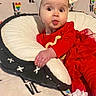 Caroline is registered to the contest to win money with this photo: baby, child, red_clothing, headband, pillow, blanket, love_pattern, tongue_out, cute, funny_face, indoor, smiling, infant, cozy, toddler, white_socks, plush, portrait, colorful, happy