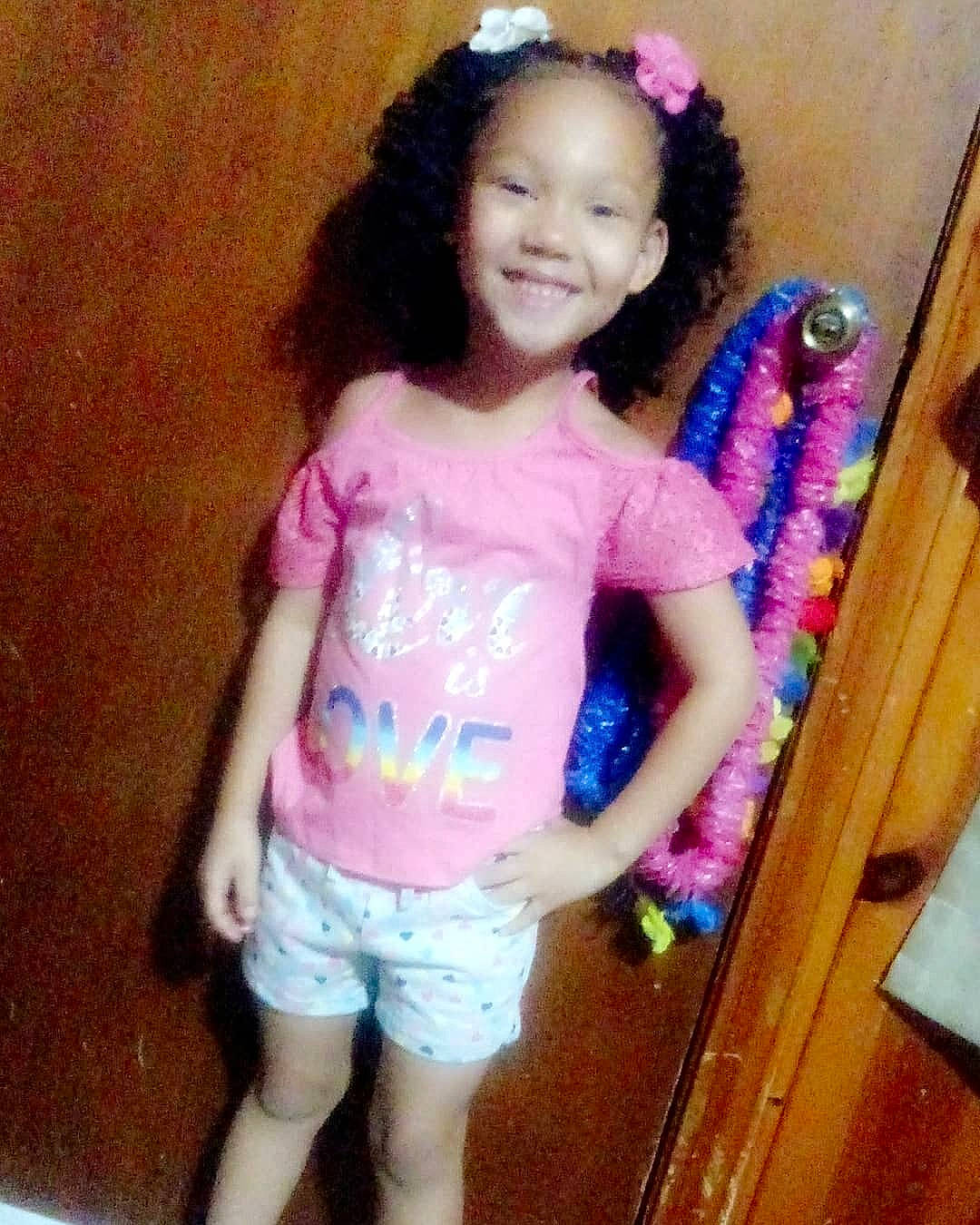 Zavriana is registered to the contest to win money with this photo: child, hair, hairstyle, joy, long_hair, person, pink, smile, standing, t_shirt, toddler, toy