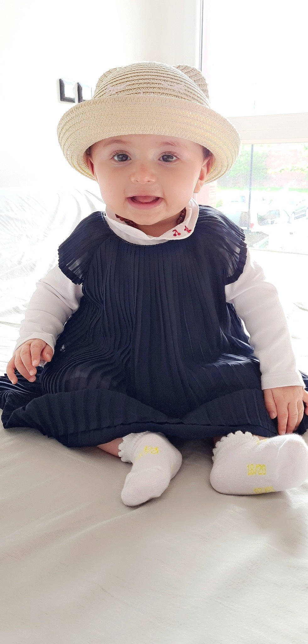 Ayline participe au concours pour gagner de l'argent avec cette photo : baby, baby_products, baby_toddler_clothing, cap, child, costume_hat, fashion_accessory, happy, hat, headwear, jewellery, outerwear, pattern, person, sitting, skin, sleeve, smile, sun_hat, t_shirt