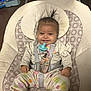 Arriya is registered to the contest to win money with this photo: baby, clothing, coat, crib, cushion, cutlery, face, furniture, happy, head, homedecor, infantbed, jacket, pants, person, photography, portrait, sitting, smile, spoon